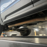 Close-up of a vehicle on a lift in a garage setting