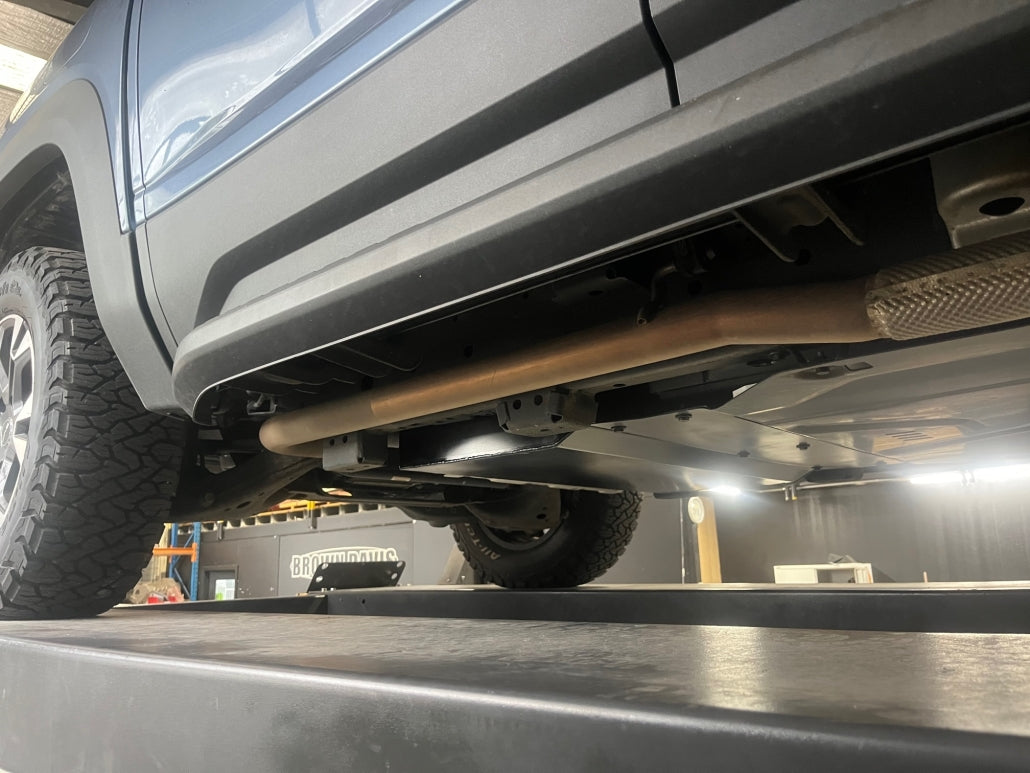 Close-up of a vehicle on a lift in a garage setting