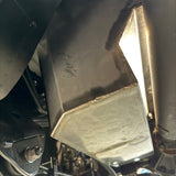 Close-up of a under vehicle water tank system with a focus on the metal components.