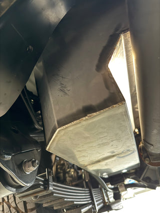 Close-up of a under vehicle water tank system with a focus on the metal components.