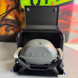 Portable grill on a speckled surface with colorful background