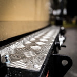 Metallic surface with geometric patterns on a blurred background