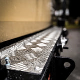 Metallic surface with geometric patterns on a blurred background