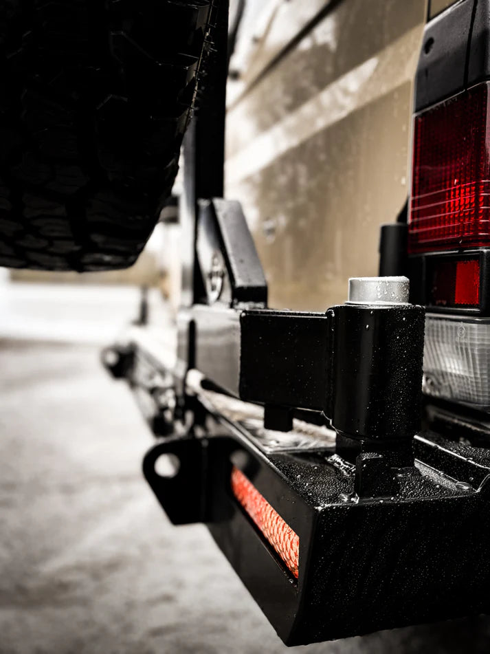 Close-up of a vehicle's hitch and trailer attachment on a road.