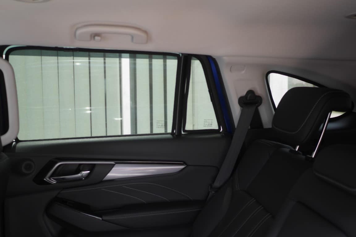 Car interior with a sunshade covering the rear window