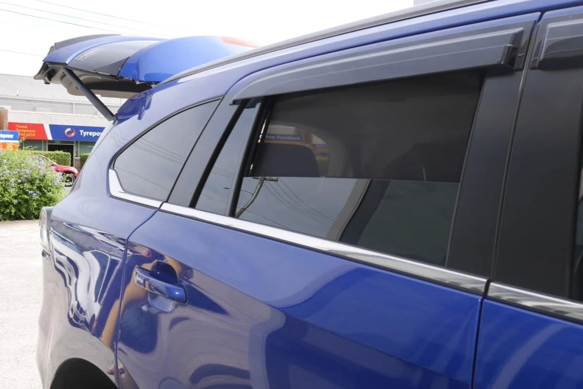 Blue car with a roof rack in a parking lot