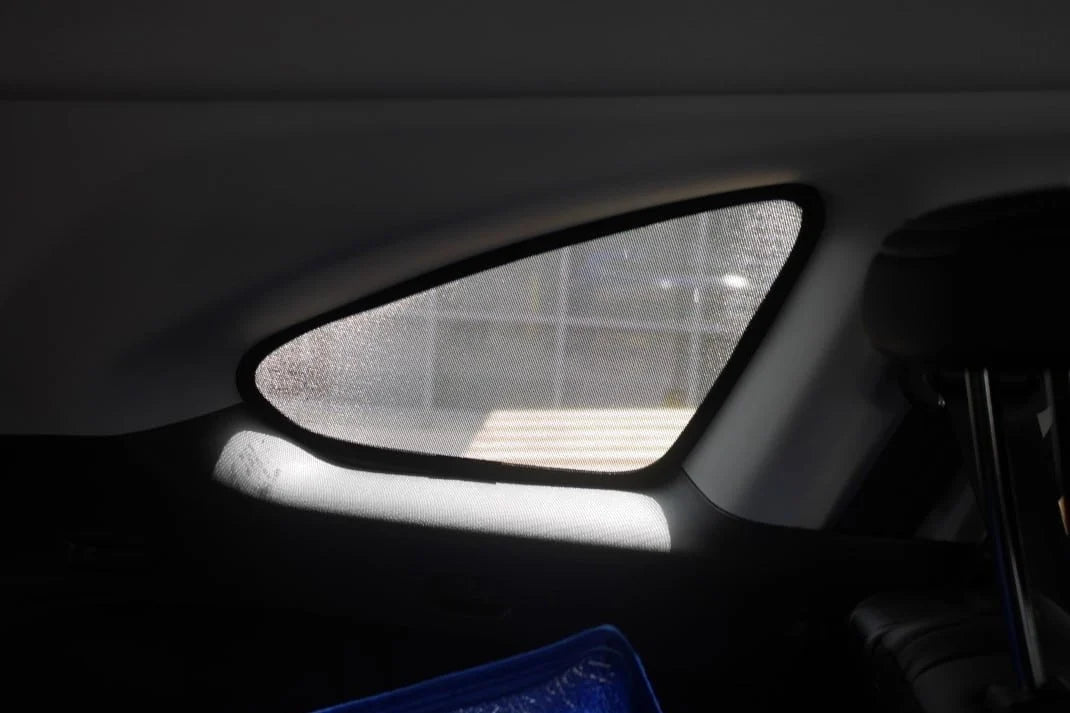 Car interior with a sunshade covering the windshield