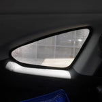 Car interior with a sunshade covering the windshield