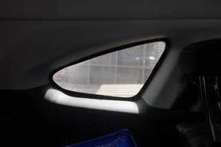 Car interior with a sunshade covering the windshield