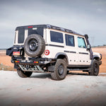 White off-road vehicle with a spare tire on a desert landscape