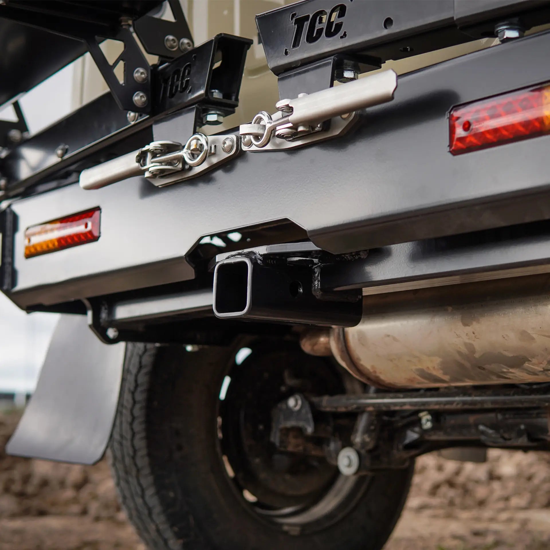 Close-up of a vehicle's hitch and trailer attachment system with 'TCC' branding.