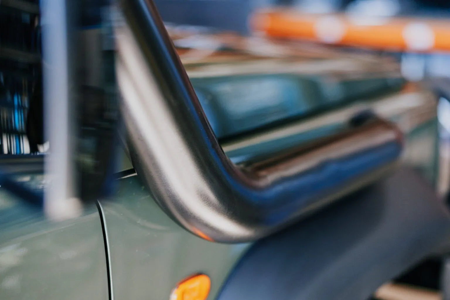 Close-up of a vehicle's side mirror with a blurred background
