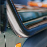 Close-up of a vehicle's side mirror with a blurred background