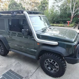 Green SUV with roof rack parked on a concrete surface