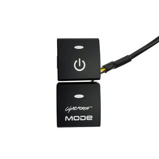 Two-position Lightforce switch blank set, an upper button with a power symbol and a lower blank carrying the Lightforce MODE name, with the wiring loom leaving the back