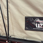 Close-up of a label on a tent with 'The Bush Company' branding and 'LX27' model number.
