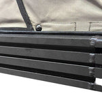 Close-up of a black metal bar with a beige fabric background