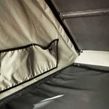 Close-up of a tent interior with a window and fabric details.