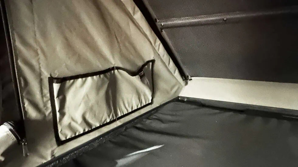 Close-up of a tent interior with a window and fabric details.