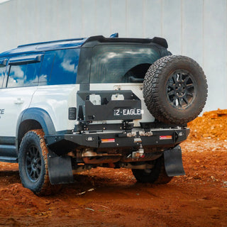 Off-road vehicle with large tire and additional wheel on a dirt surface
