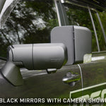 Car side mirror with built-in camera on a vehicle, with text indicating 'Black mirrors with camera shown'.