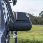 Side view of a vehicle's mirror with a blurred natural background
