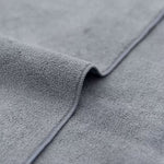 Close-up of gray textured fabric with a focus on texture and color.