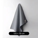 Gray towel hanging on a white wall with dimensions 125 x 70 cm displayed below.