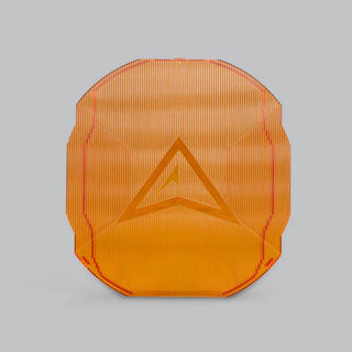 Amber ALTIQ Rogue panoramic lens cover, translucent orange with fine vertical ribbing and the raised Rogue chevron moulded into the centre