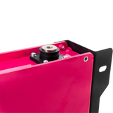 Close-up of a pink metal component with black and silver parts on a white background