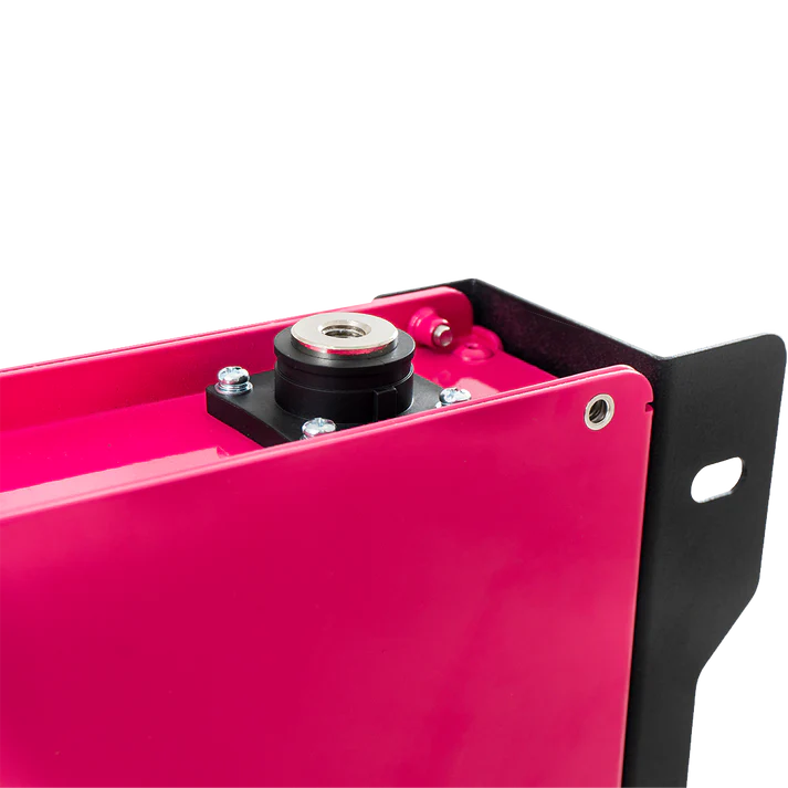 Close-up of a pink metal component with black and silver parts on a white background