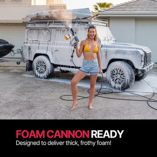 Woman washing a white SUV with the Blahst R30 Wall-Mounted Pressure Washer foam cannon in front of a house.