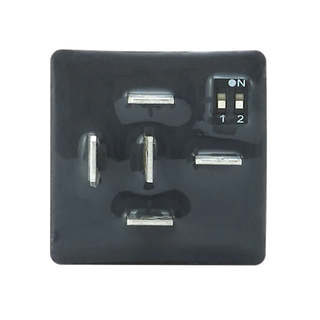 Base of the REDARC Multi Function Timer showing the five spade terminals and the two-position DIP switch