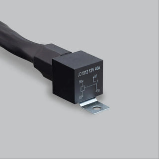 Close-up of the harness relay, a black cube printed JD1912 12V 40A with the coil and contact diagram and terminals 85, 86, 87 and 30 marked, on a zinc-plated mounting bracket