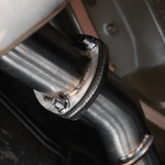 Close-up of a metal exhaust pipe with a bolt, likely from a vehicle.