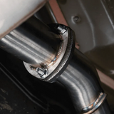 Close-up of a metal exhaust pipe with a bolt, likely from a vehicle.
