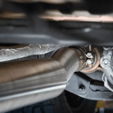 Close-up of a car exhaust system with a focus on the pipe and mounting hardware.