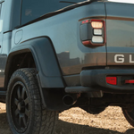 Close-up of a blue Jeep Gladiator in an outdoor setting