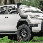 White Toyota truck in a forest setting