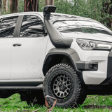 White Toyota truck in a forest setting