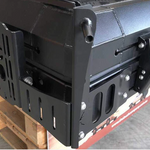 Close-up of the Bush Company Spring Rod Adapter bracket on a wooden pallet.