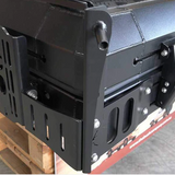 Close-up of the Bush Company Spring Rod Adapter bracket on a wooden pallet.