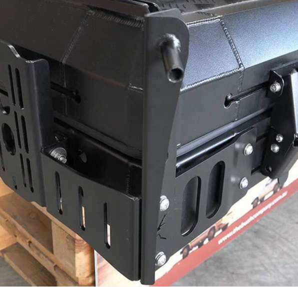 Close-up of the Bush Company Spring Rod Adapter bracket on a wooden pallet.