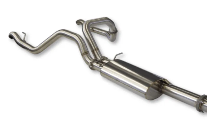 Stainless cat-back exhaust laid out, showing the front pipe bending over the rear axle, the twin-inlet Y section and the main muffler with its hangers