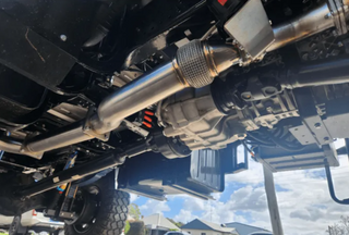 Close-up of a vehicle's undercarriage with suspension components.