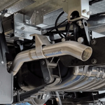 Close-up of a car exhaust system with 'torqit' branding.