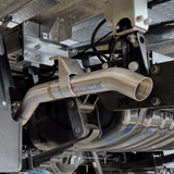 Close-up of a car exhaust system with 'torqit' branding.
