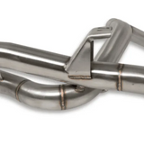 Close-up of a stainless steel exhaust system on a white background