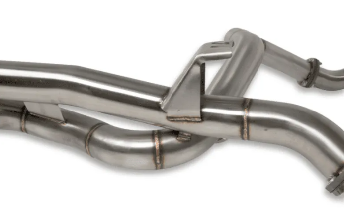 Close-up of a stainless steel exhaust system on a white background