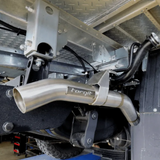 Close-up of a metallic exhaust system with 'torqit' branding on a vehicle.